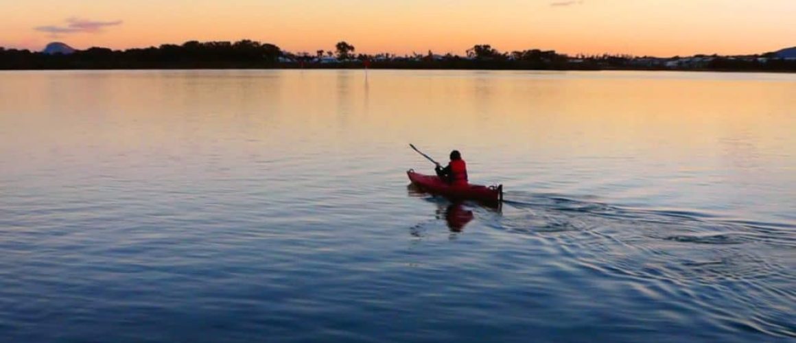 A kayaker just relaxing at sunset to relieve stress