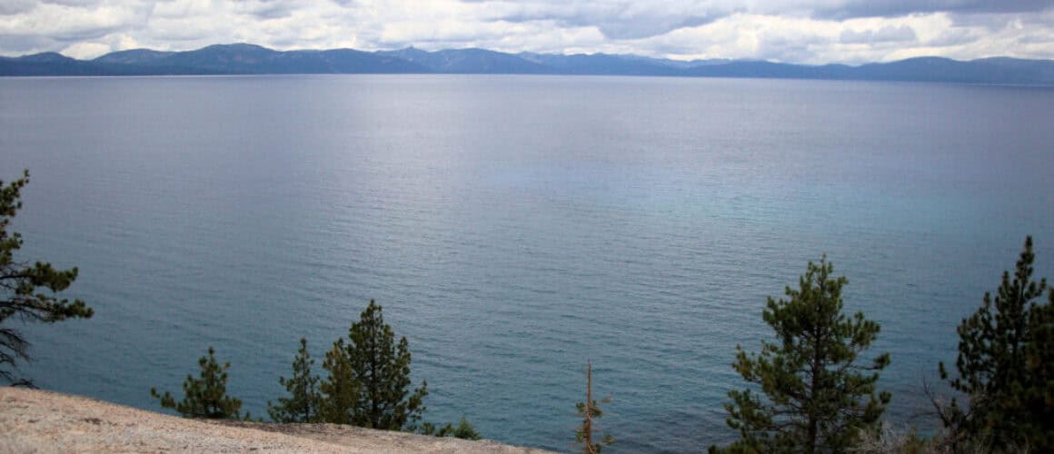 Kayaker paddling through crystal clear mountain lake