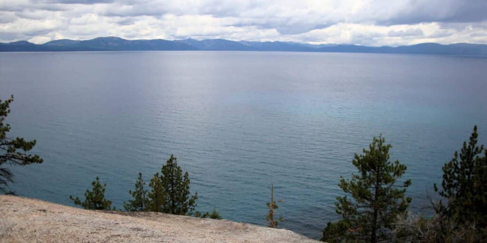 Kayaker paddling through crystal clear mountain lake
