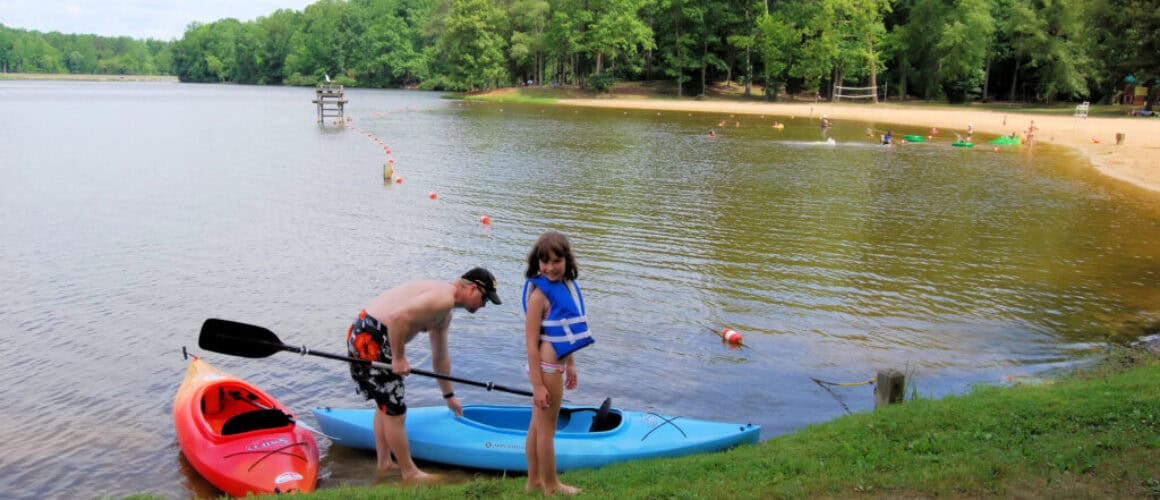 Family group kayaking together on calm water
