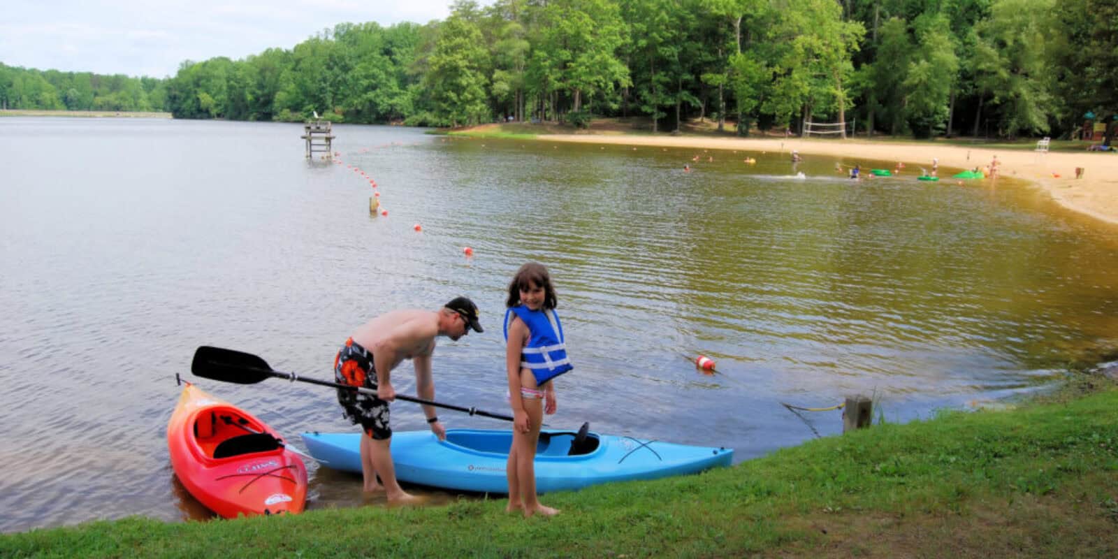 Family group kayaking together on calm water