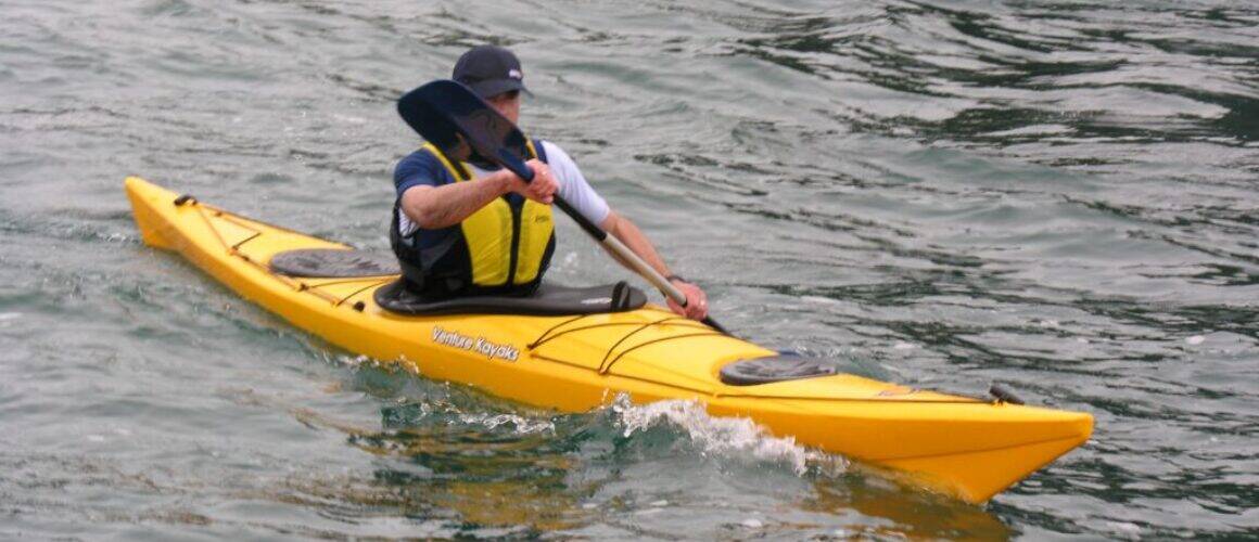Sea kayak paddler navigating ocean waters