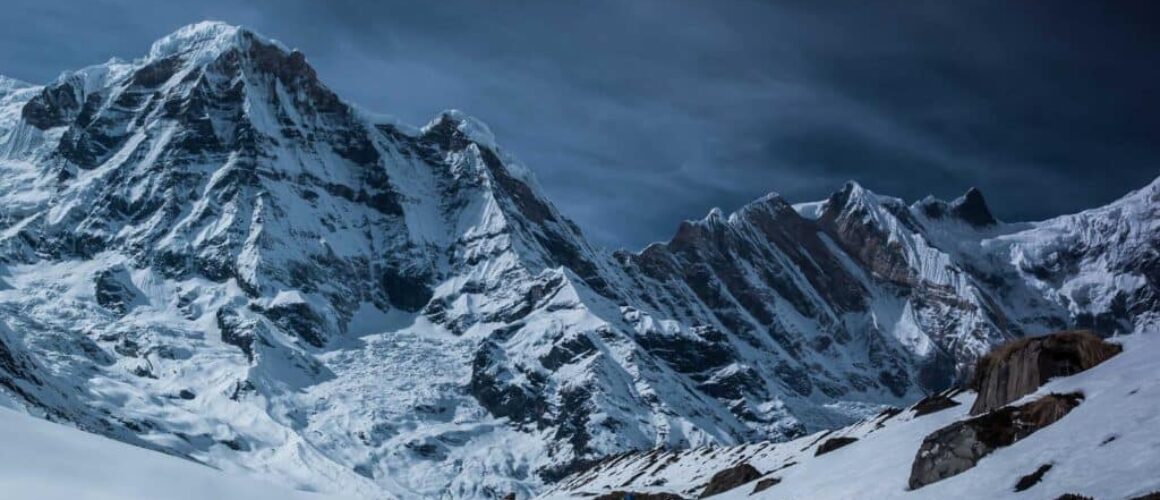 Beginner kayaker in drysuit launching on a cold lake with safety gear