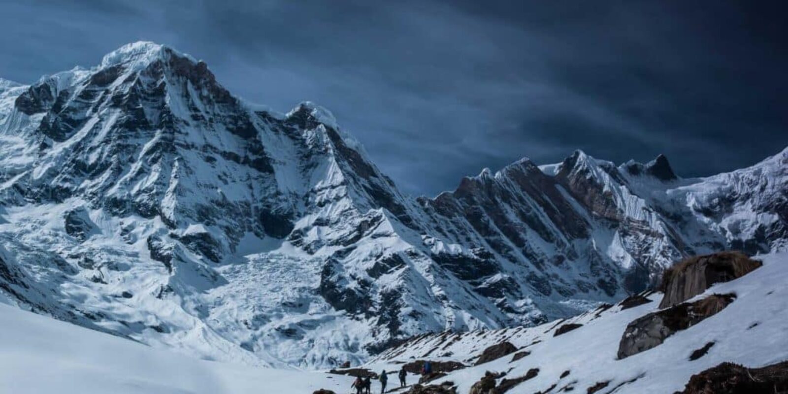 Beginner kayaker in drysuit launching on a cold lake with safety gear