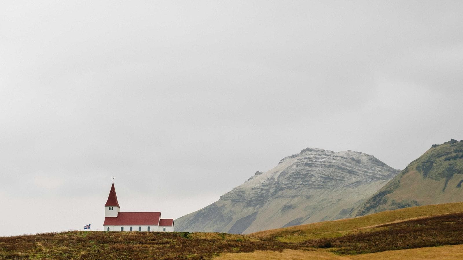 Early spring river bend with fallen trees and fast current creating strainer hazards for paddlers